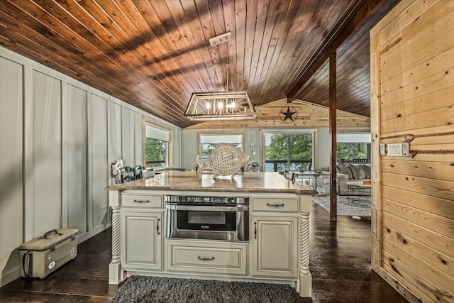 kitchen featuring vaulted ceiling, dark hardwood / wood-style floors, oven, and a healthy amount of sunlight