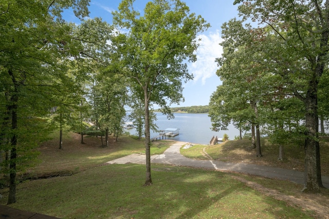 view of community with a water view and a yard