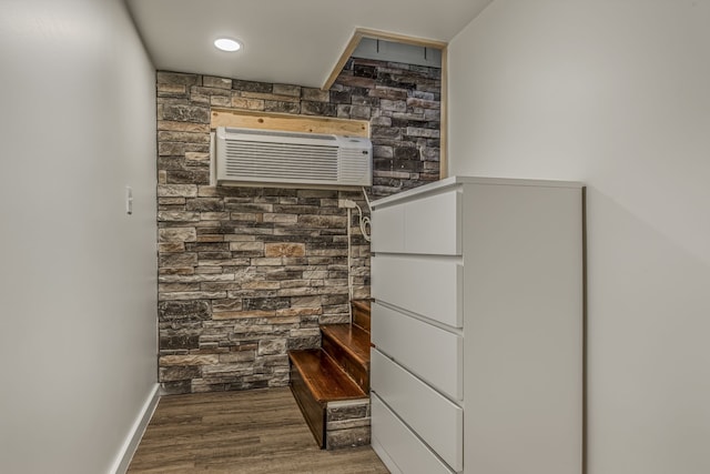 spacious closet with a wall unit AC and hardwood / wood-style flooring