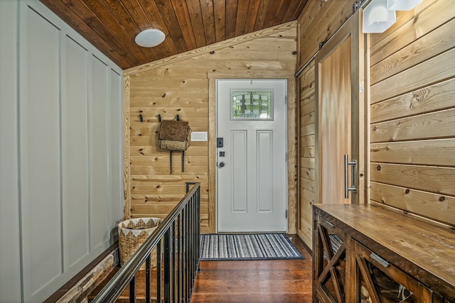 interior space with wooden ceiling, lofted ceiling, wooden walls, and dark hardwood / wood-style flooring