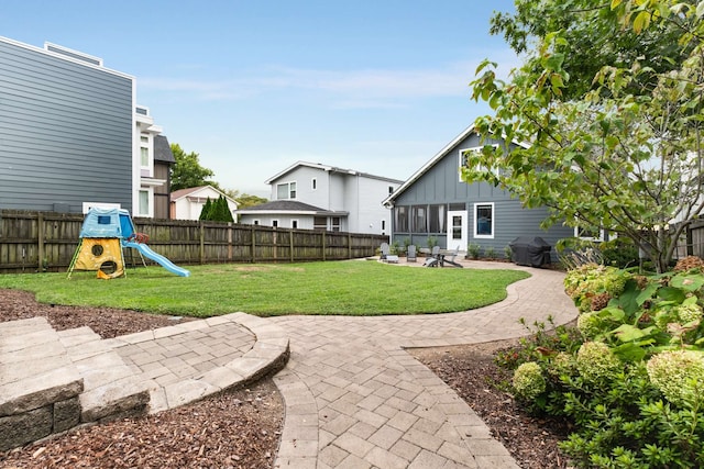 view of yard featuring a patio area and a playground