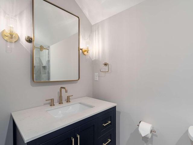 2310 Vaulx Ln, Nashville, TN 37204 - bathroom featuring toilet, vanity, and vaulted ceiling