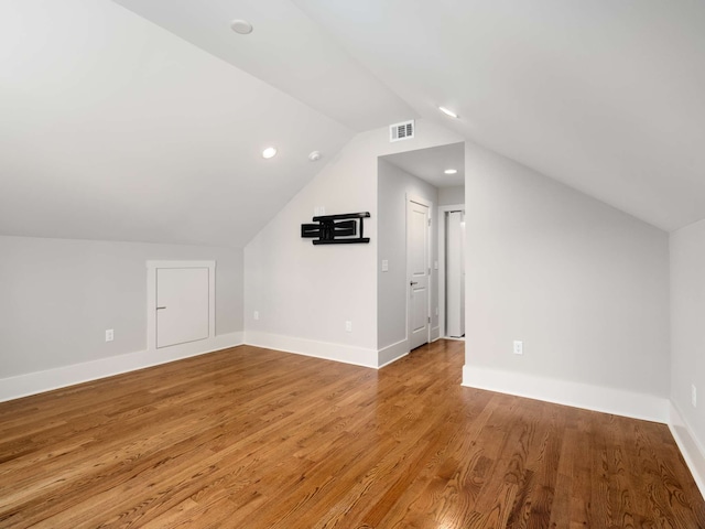 additional living space with lofted ceiling and light wood-type flooring