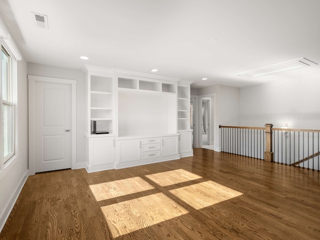 unfurnished living room featuring dark wood-type flooring