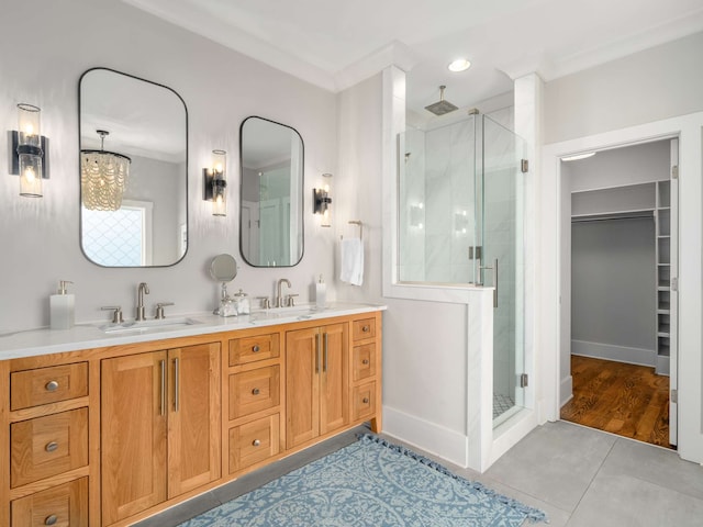 bathroom featuring crown molding, vanity, and a shower with shower door