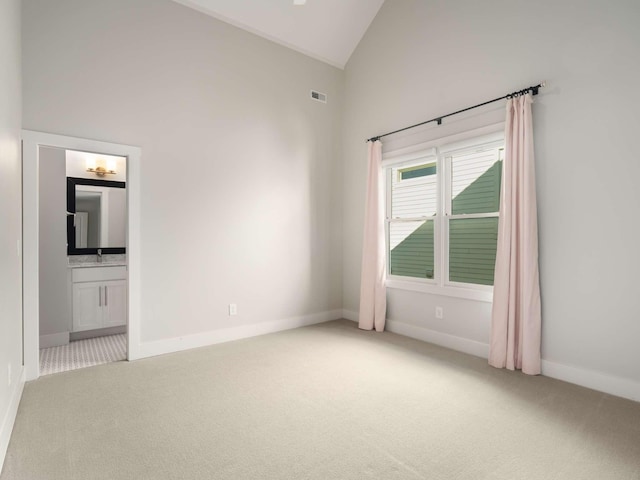 2310 Vaulx Ln, Nashville, TN 37204 - spare room featuring carpet floors, high vaulted ceiling, and baseboards