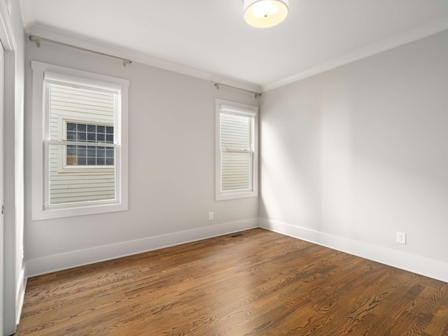 unfurnished room with crown molding and dark hardwood / wood-style floors