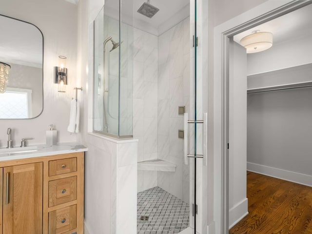 bathroom featuring an enclosed shower, vanity, and hardwood / wood-style flooring