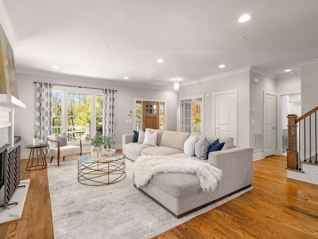 2310 Vaulx Ln, Nashville, TN 37204 - living area with stairs, ornamental molding, light wood-style flooring, recessed lighting, and a fireplace with raised hearth