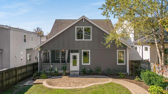 2310 Vaulx Ln, Nashville, TN 37204 - back of house featuring board and batten siding, a sunroom, and a patio area