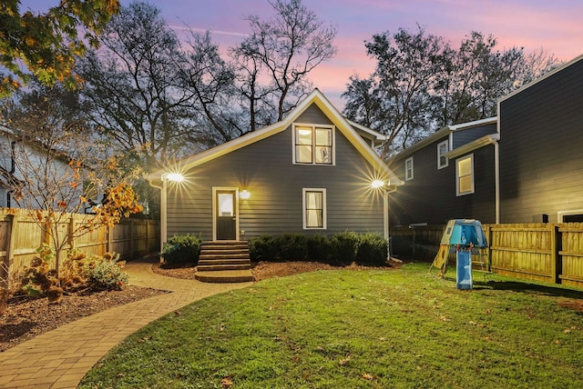 back house at dusk with a yard