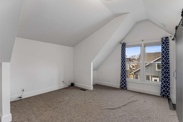 additional living space featuring lofted ceiling and carpet floors