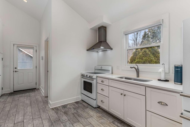 kitchen featuring white cabinetry, white electric range, sink, and wall chimney range hood