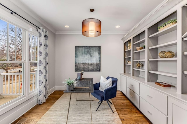 living area featuring ornamental molding and dark hardwood / wood-style flooring