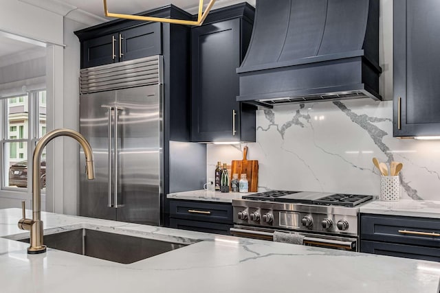 kitchen featuring light stone counters, crown molding, custom range hood, and premium appliances