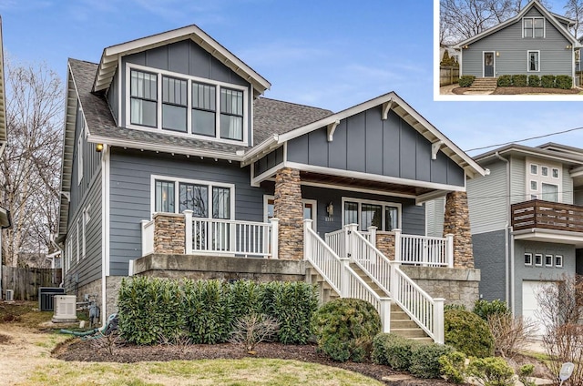 craftsman-style house with board and batten siding, a shingled roof, central air condition unit, stairway, and covered porch