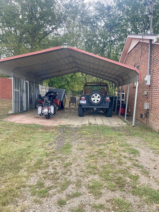 view of car parking featuring a lawn and a carport