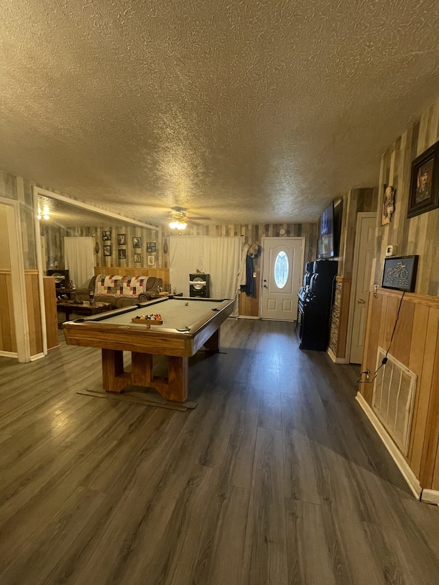 playroom with dark wood-type flooring, a textured ceiling, and billiards