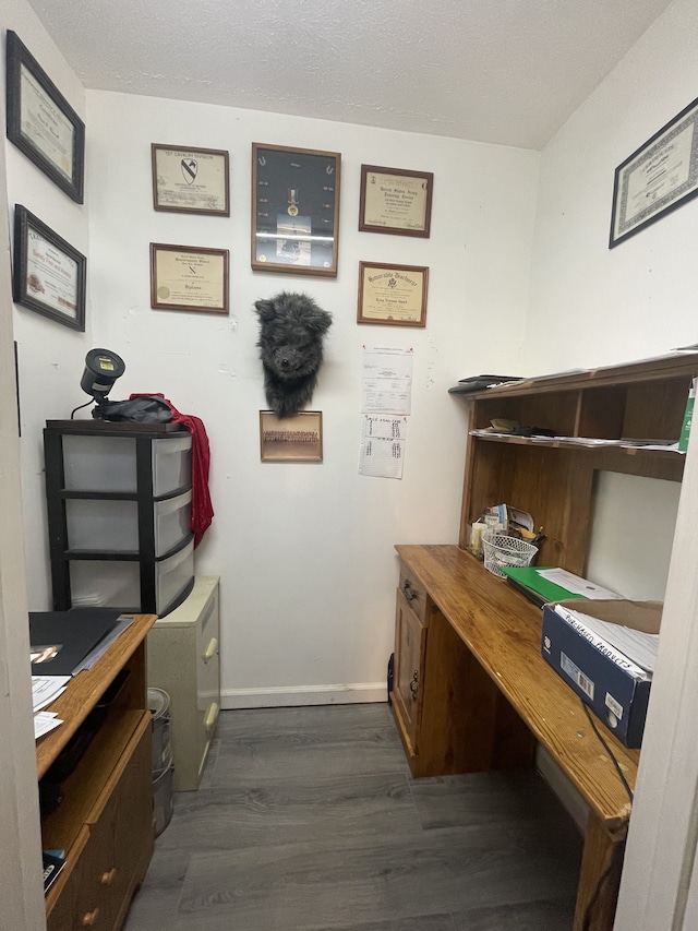 office with a textured ceiling and dark hardwood / wood-style floors