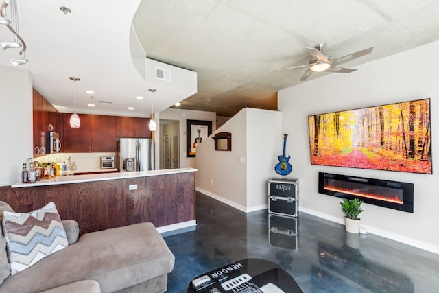 living room with visible vents, a ceiling fan, a glass covered fireplace, finished concrete floors, and baseboards