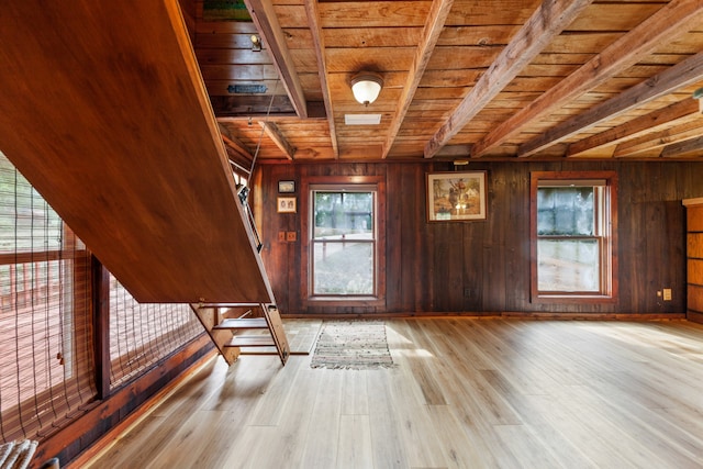 unfurnished room featuring wooden ceiling, a healthy amount of sunlight, and light hardwood / wood-style floors