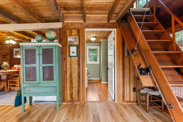 interior space featuring wood ceiling, beamed ceiling, hardwood / wood-style floors, and wood walls