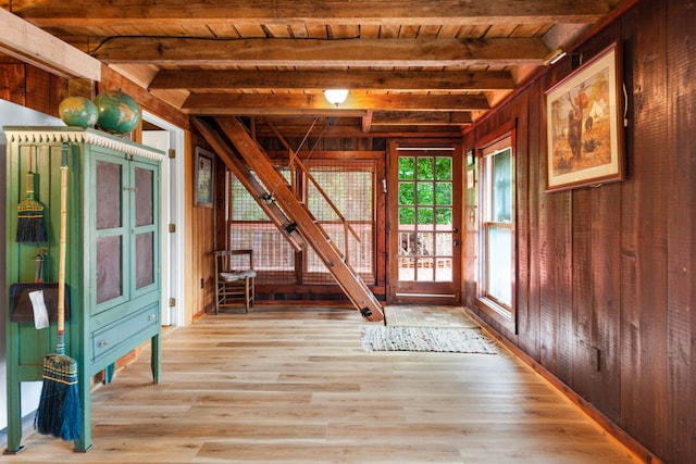 interior space featuring wooden ceiling, hardwood / wood-style floors, beam ceiling, and wooden walls