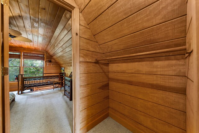 interior space featuring vaulted ceiling, ceiling fan, and carpet