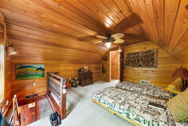 carpeted bedroom featuring wood ceiling, ceiling fan, wooden walls, and vaulted ceiling