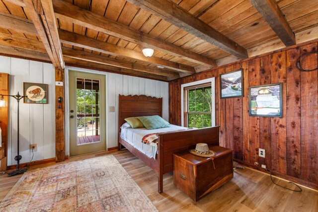 bedroom with wooden ceiling, multiple windows, hardwood / wood-style floors, and beam ceiling