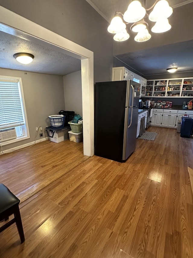 1694 Verona Caney Rd, Lewisburg, TN 37091 - kitchen with freestanding refrigerator, white cabinetry, wood finished floors, a chandelier, and dark countertops