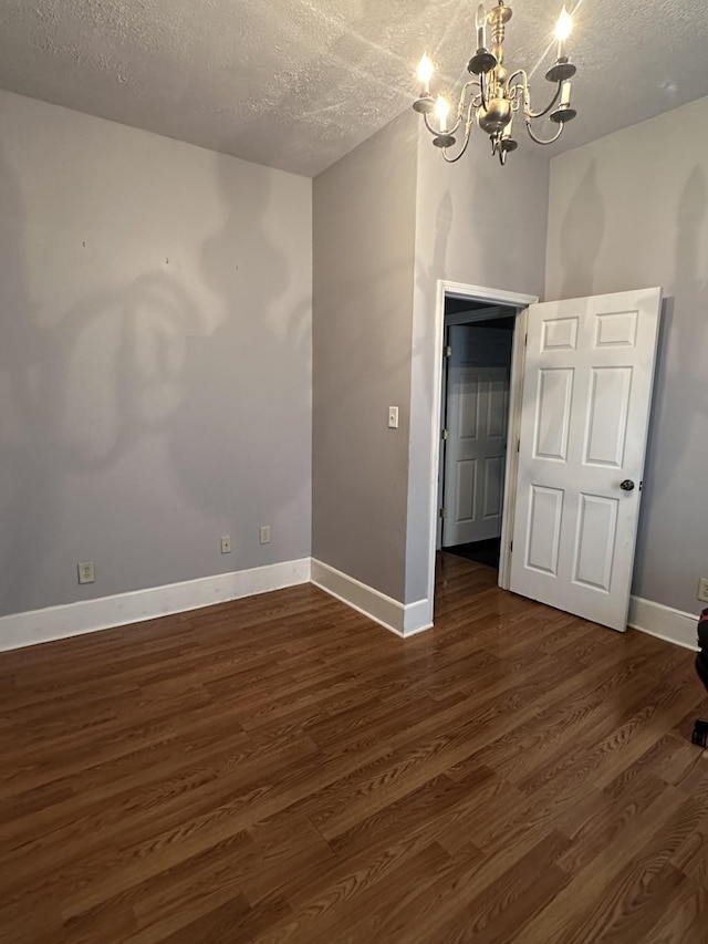 1694 Verona Caney Rd, Lewisburg, TN 37091 - unfurnished room with a chandelier, a textured ceiling, dark wood finished floors, and baseboards