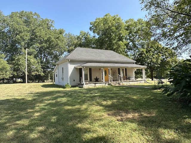 view of front of home with a front yard and covered porch