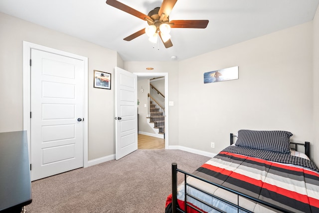 bedroom featuring ceiling fan and light carpet