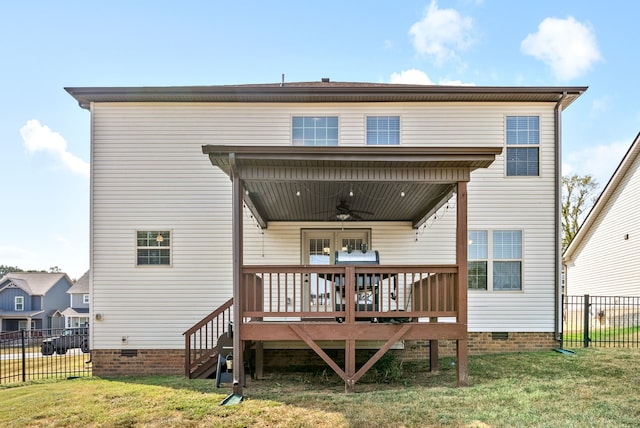 rear view of house featuring a yard, ceiling fan, and a deck