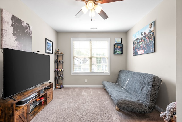 sitting room with light colored carpet and ceiling fan