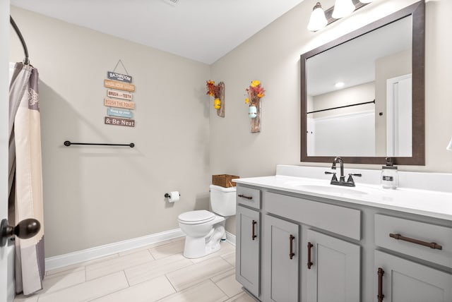 bathroom with vanity, toilet, and walk in shower