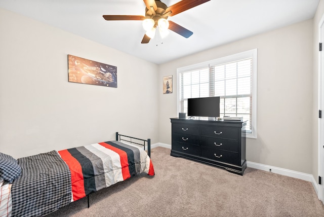 bedroom featuring ceiling fan and light carpet