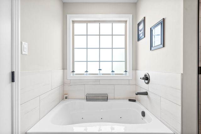 bathroom featuring a wealth of natural light and a tub