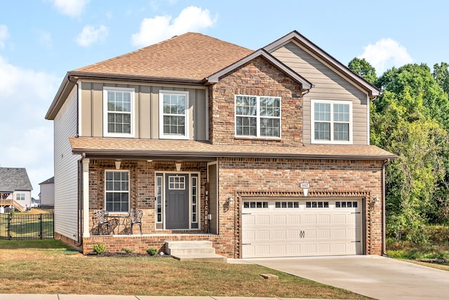 view of front of property featuring a garage and a front lawn