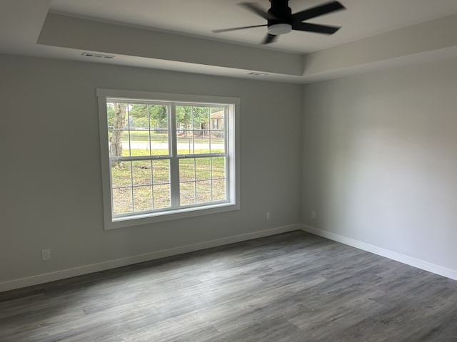 spare room with hardwood / wood-style flooring and ceiling fan