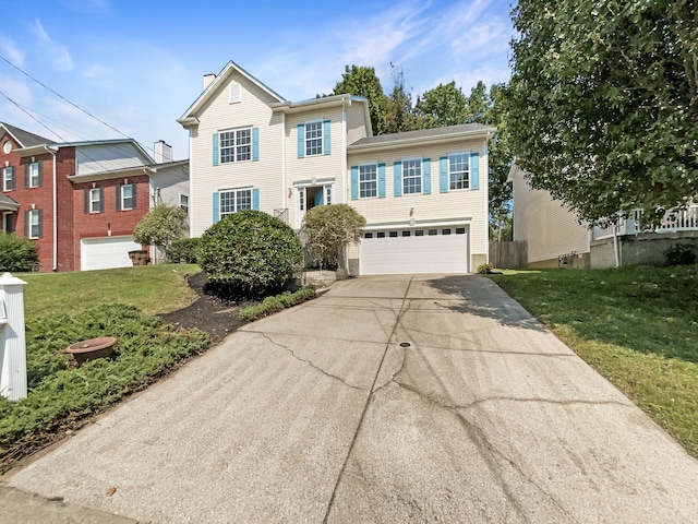 view of front of home with a garage and a front lawn