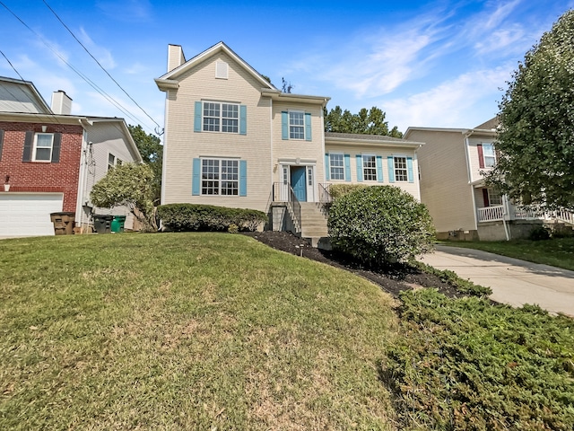 view of front of house featuring a garage and a front lawn