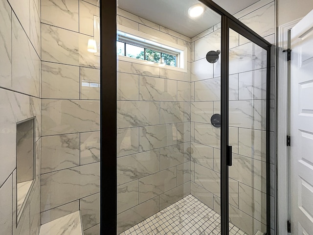 bathroom with a shower with door