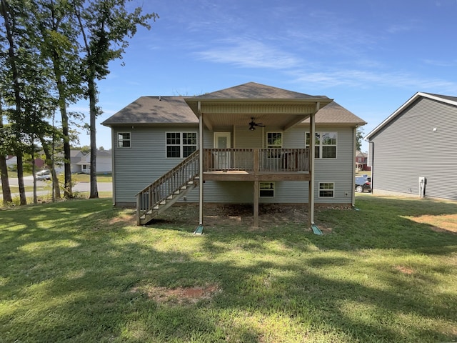 rear view of house with ceiling fan, a yard, and a wooden deck