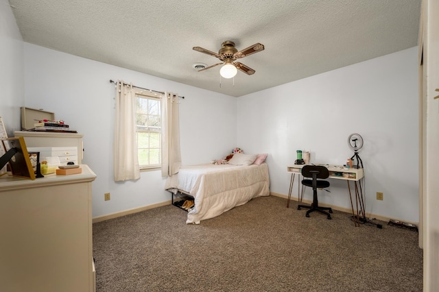 carpeted bedroom featuring ceiling fan and a textured ceiling