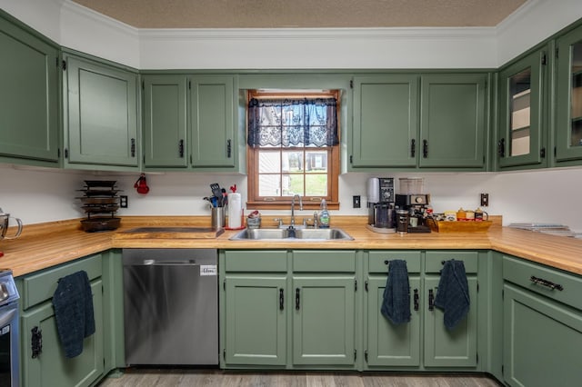 kitchen featuring green cabinetry, appliances with stainless steel finishes, ornamental molding, and sink