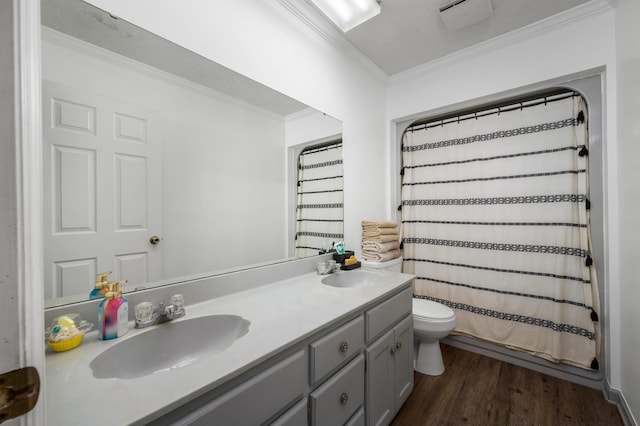 bathroom with vanity, hardwood / wood-style floors, walk in shower, crown molding, and toilet