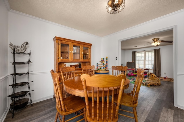 dining room with ornamental molding, ceiling fan, dark hardwood / wood-style floors, and a textured ceiling