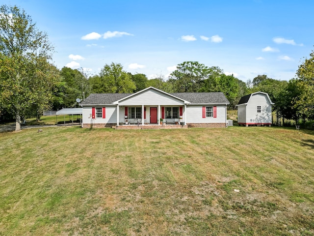 ranch-style house featuring a storage shed, a front yard, and a porch